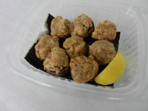 Fried oyster bites served with a lemon wedge.